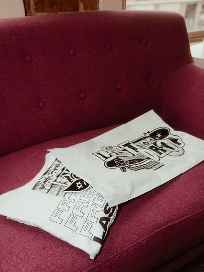 Product packaging on a stylish couch in front of a window.